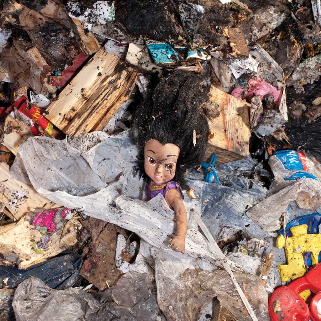 A doll is buried amidst the trash at the New Bedford landfill.