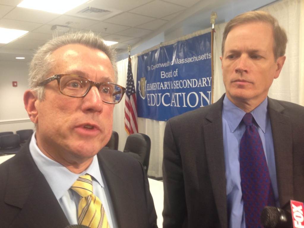State education commissioner Mitchell Chester, left, and Education Secretary Jim Peyser speak with reporters following the Board of Elementary and Secondary Education meeting on Tuesday.
