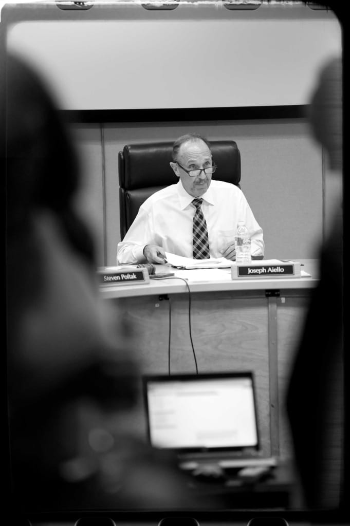 Joseph Aiello, chairman of the Fiscal and Management Control Board, presides over a recent public session.