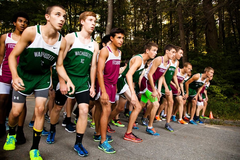 The cross country teams of Fitchburg High School and Wachusetts Regional High School line up for the start of a race. Photo by Meghan Moore.