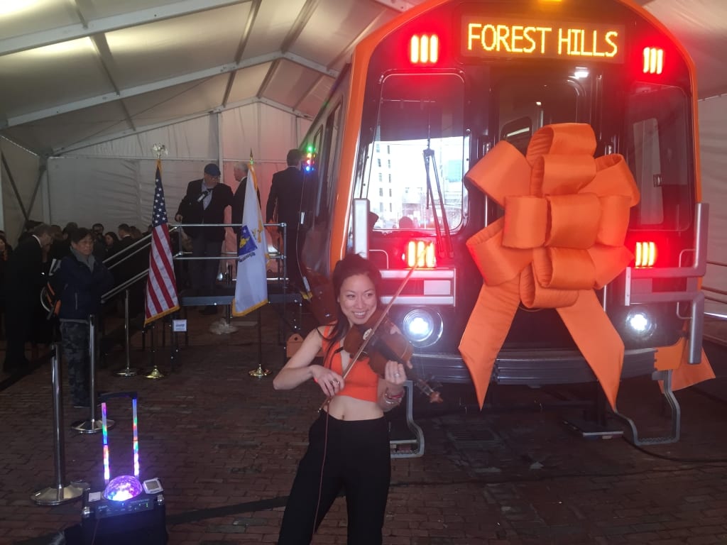 Vivian Luo, who performs inside T stations and also at the opening of Government Center station, played at the unveiling of the Orange Line prototype.