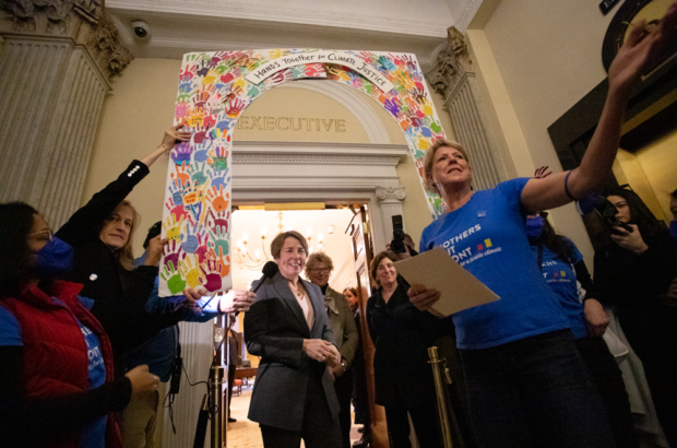 Healey greets Mothers Out Front at her office door